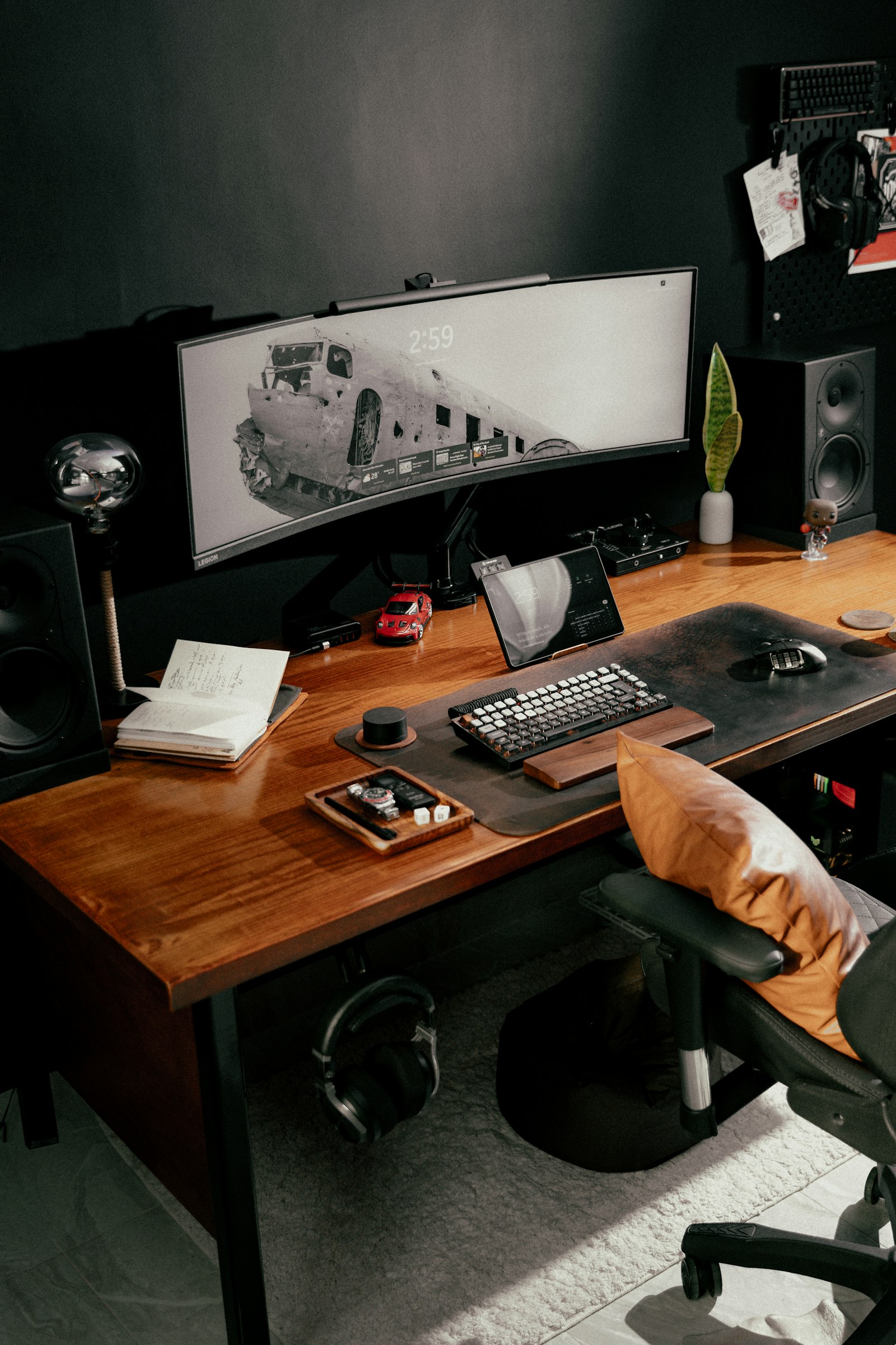 Modern computer desk setup with curved monitor