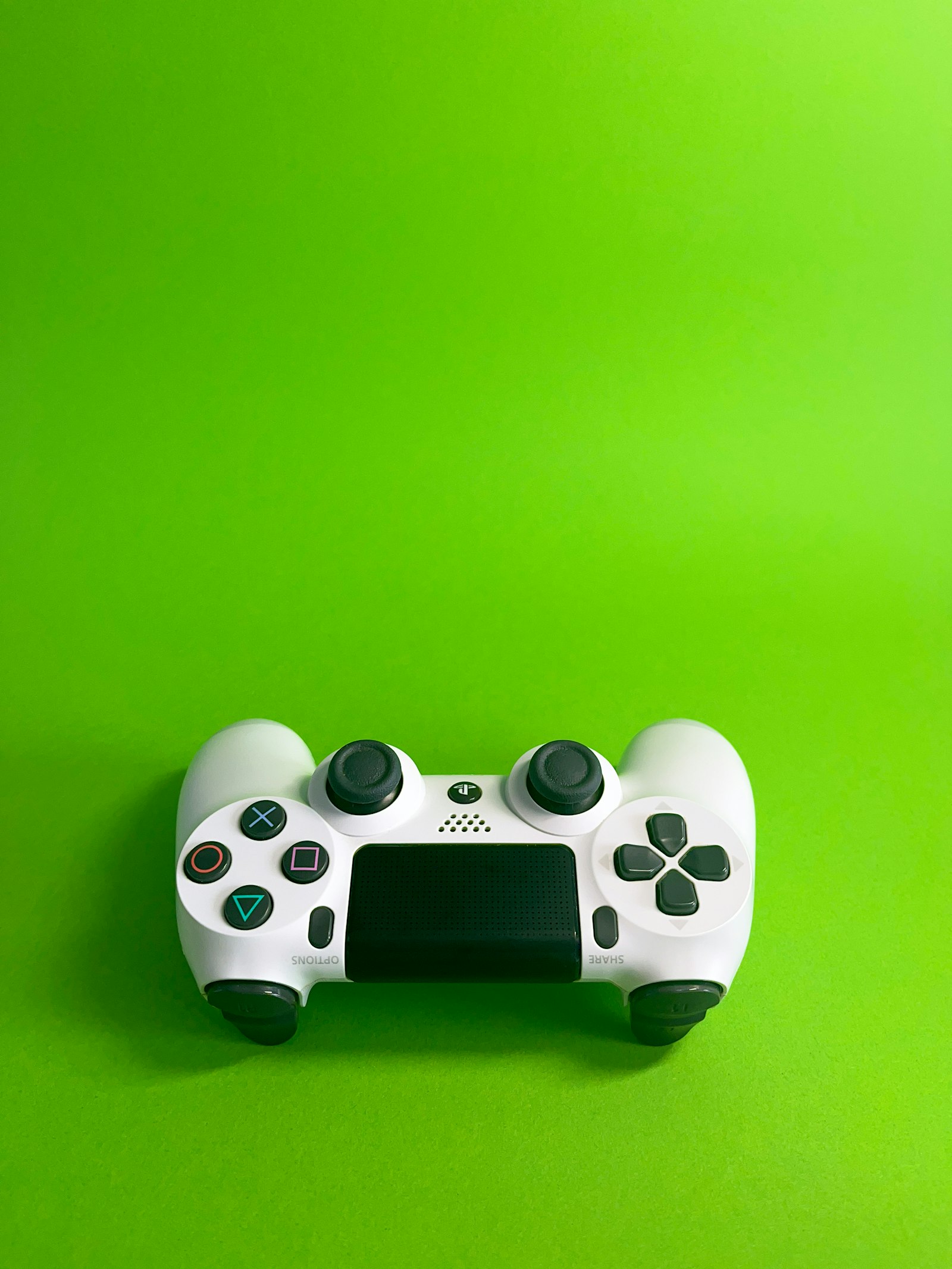 Video game controller on a green background (generic stock photo)